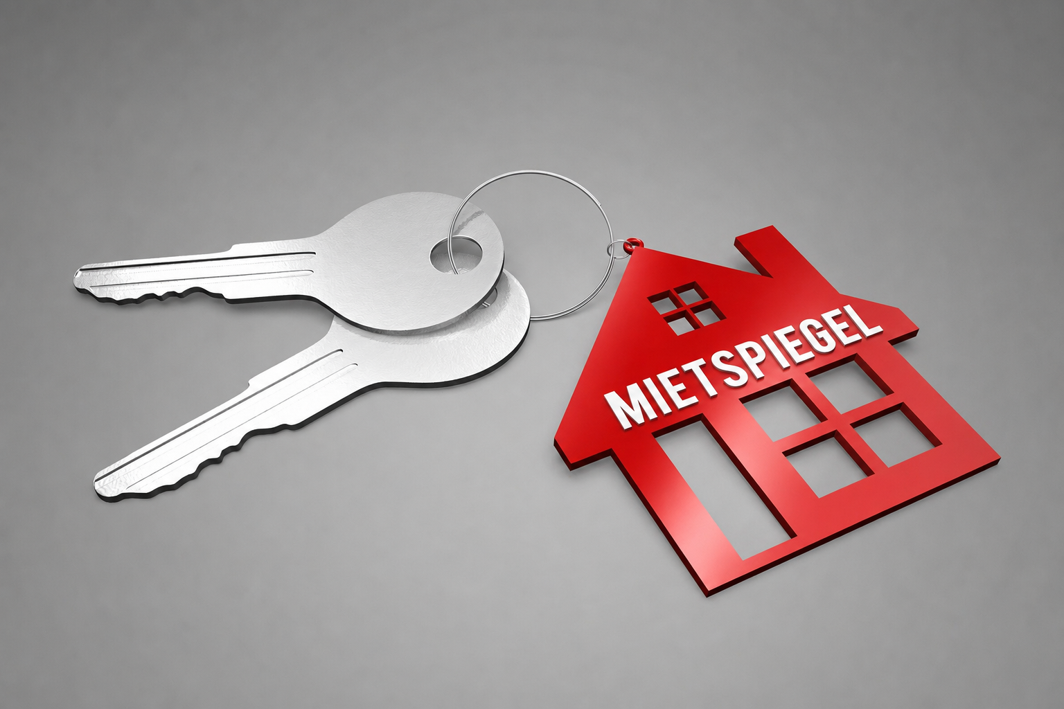 Zwei Schlüssel mit einem Roten Haus als Anhänger auf dem "Mietspiegel" steht.
